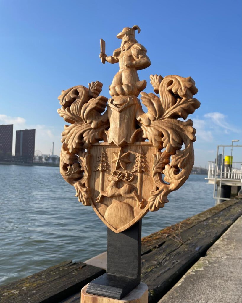 Wooden heraldic coat of arms with lions and ship sculpture on dock