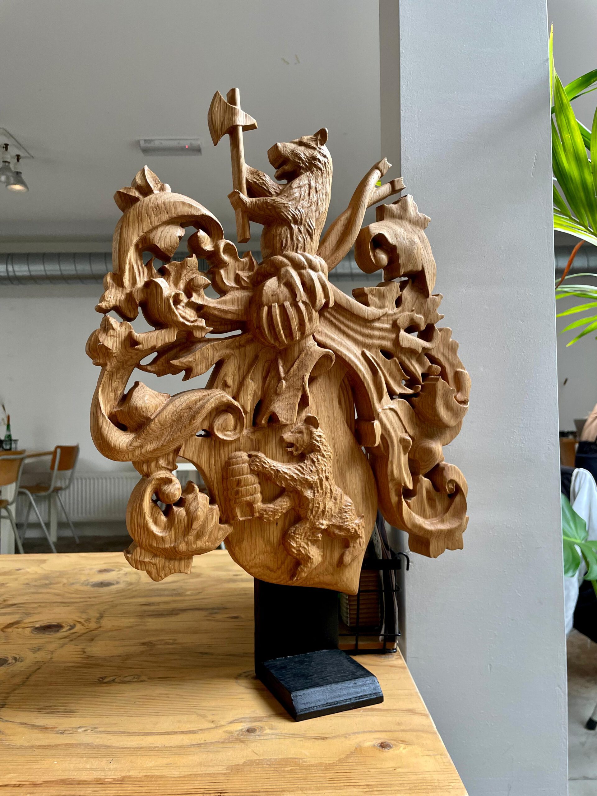 Hand-carved wooden coat of arms with intricate family crest details