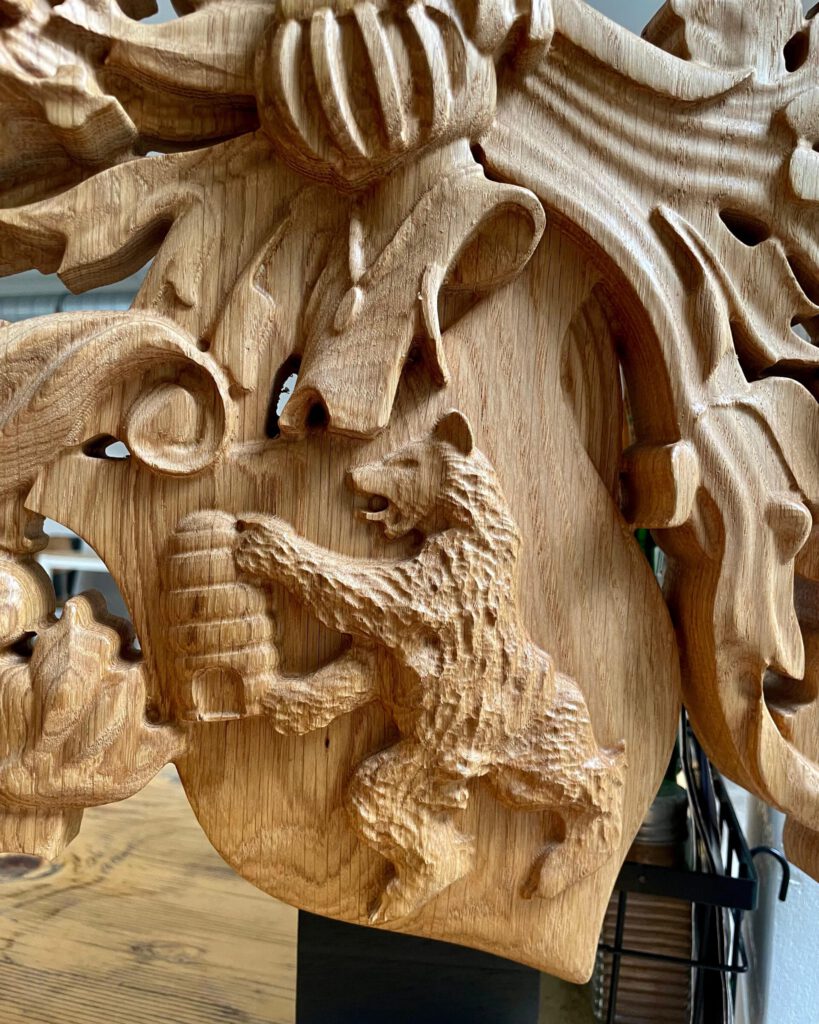 Custom wooden coat of arms lion carving with detailed relief work and heraldic design