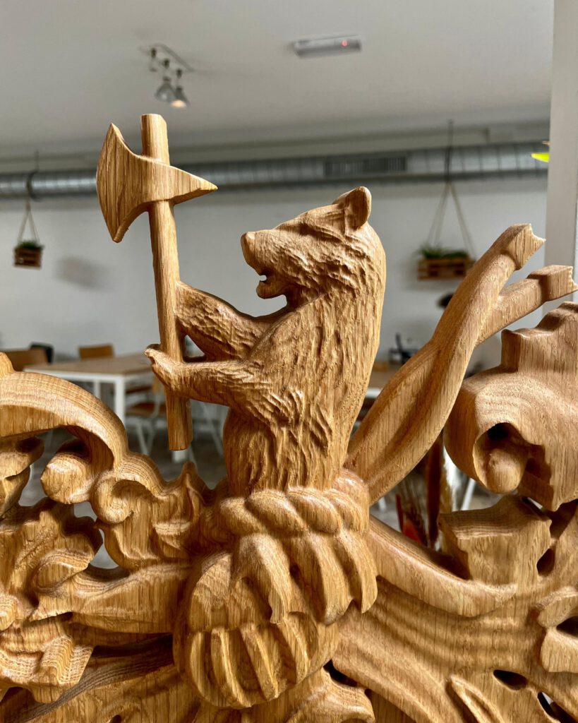 Carved wooden heraldic lion with cross sculpture