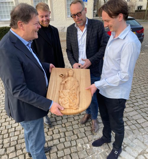 High-relief wood carving featuring a noble crest and shield design